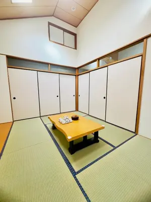 a room with a table in a room with white cabinets at Hao Bros. Home \u548c(WA) in Tokyo