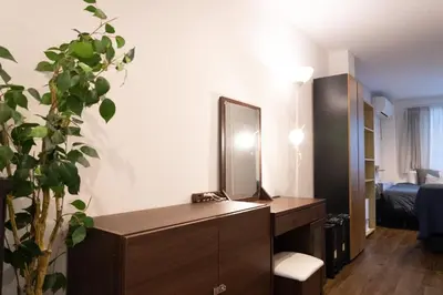 a room with a desk with a mirror and a bedroom at Higashi Shinagawa Apartment by Tranova in Tokyo