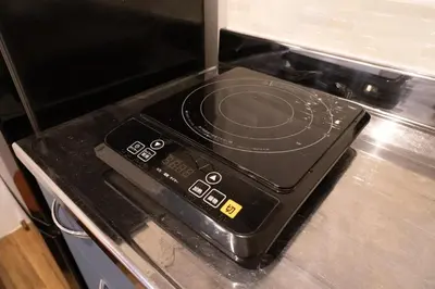 a stove top oven with a control panel on it at Higashi Shinagawa Apartment by Tranova in Tokyo