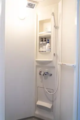 a bathroom with a shower with a toilet in it at Higashi Shinagawa Apartment by Tranova in Tokyo