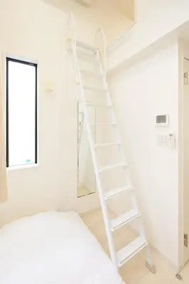 a white ladder in a white room with a bed at Nano North Shinjuku Apartment by Tranova in Tokyo