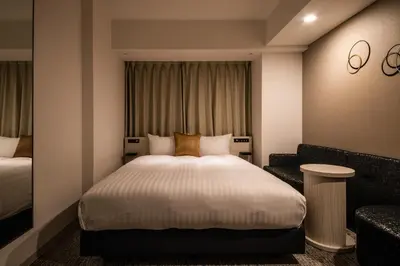 a hotel room with a bed and a chair at Hotel Vista Tokyo Tsukiji in Tokyo
