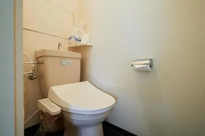a bathroom with a white toilet in a room at Miki Hall Akabane in Tokyo
