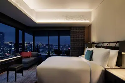 a bedroom with a bed and a view of a city at mesm Tokyo, Autograph Collection in Tokyo
