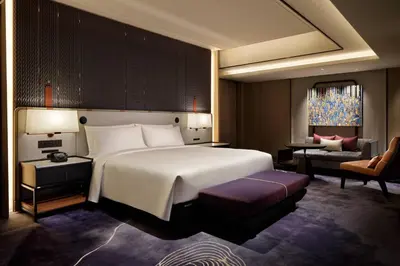 a bedroom with a large white bed and a chair at mesm Tokyo, Autograph Collection in Tokyo