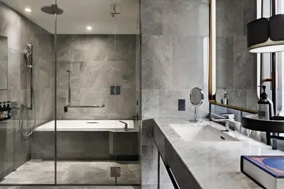 a bathroom with a tub and a sink and a shower at mesm Tokyo, Autograph Collection in Tokyo