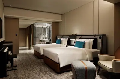 a hotel room with two beds and a piano at mesm Tokyo, Autograph Collection in Tokyo