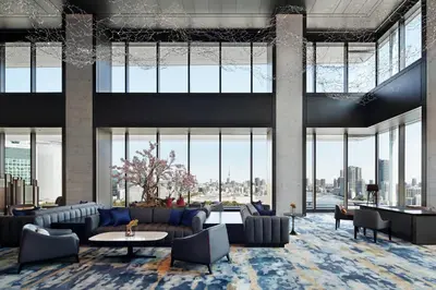 a lobby with couches and tables and large windows at mesm Tokyo, Autograph Collection in Tokyo