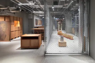 a room filled with wooden tables and chairs in a building at KAIKA Tokyo by THE SHARE HOTELS in Tokyo