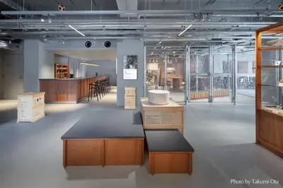 a large room with wooden cabinets and tables and windows at KAIKA Tokyo by THE SHARE HOTELS in Tokyo