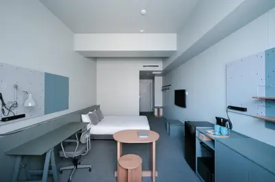 a hospital room with a bed and a table at KAIKA Tokyo by THE SHARE HOTELS in Tokyo