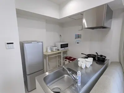 a small kitchen with a sink and a refrigerator at CIEL BLEU in Tokyo