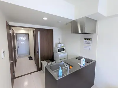 a kitchen with a sink and a microwave at CIEL BLEU in Tokyo