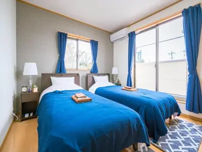 two beds in a bedroom with blue sheets at Katsushika-ku - House / Vacation STAY 5375 in Tokyo
