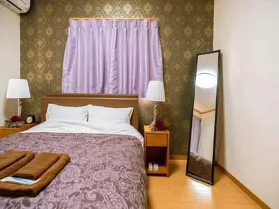a bedroom with a bed and a mirror and a window at Katsushika-ku - House / Vacation STAY 5375 in Tokyo