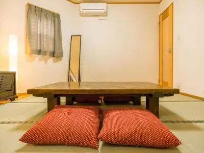 a wooden table with two red pillows on the floor at Katsushika-ku - House / Vacation STAY 5375 in Tokyo
