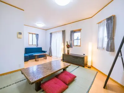 a living room with a table and a blue couch at Katsushika-ku - House / Vacation STAY 5375 in Tokyo