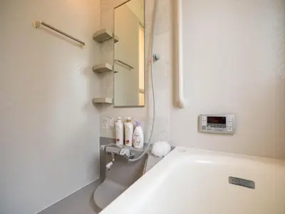 a bathroom with a tub and a sink and a mirror at Katsushika-ku - House / Vacation STAY 5375 in Tokyo