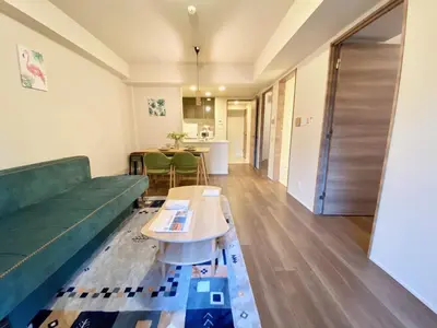 a living room with a green couch and a table at Akasaka Residence in Tokyo