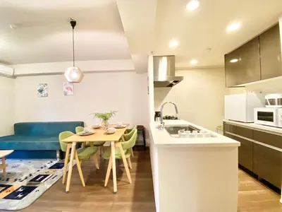 a kitchen and living room with a table and a couch at Akasaka Residence in Tokyo