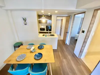 a dining room and kitchen with a wooden table and chairs at Akasaka Residence in Tokyo