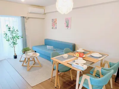 a living room with a table and a blue couch at Akasaka Residence in Tokyo