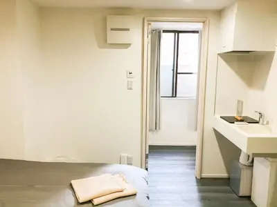 a bedroom with a bed and a sink and a window at ZAITO Tokyo Chitose Accommodation \u68ee\u4e0b\u99c5\u304b\u3089\u5f92\u6b696\u5206 in Tokyo