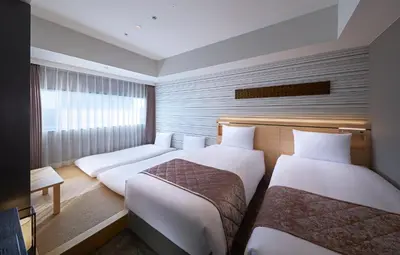 a hotel room with two beds and a window at Villa Fontaine Grand Tokyo Ariake in Tokyo