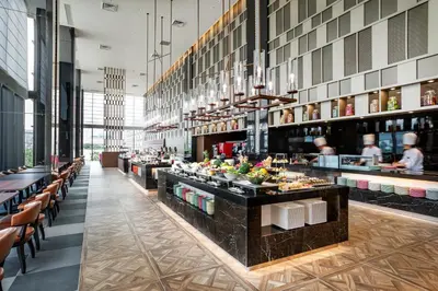a restaurant with a buffet line with people in the background at Villa Fontaine Grand Tokyo Ariake in Tokyo