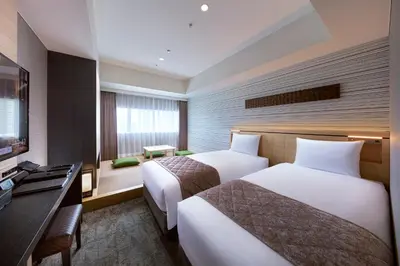 a hotel room with two beds and a television at Villa Fontaine Grand Tokyo Ariake in Tokyo