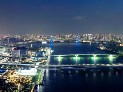 a view of a river at night with a bridge at Mitsui Garden Hotel Toyosu Premier - Tokyo in Tokyo