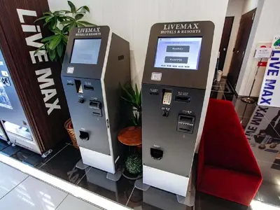 an atm machine in a store with a red seat at HOTEL LiVEMAX Shinjuku Kabukicho-Meijidori in Tokyo