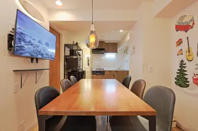 a dining room with a wooden table and chairs at V.Close to Shinjuku Kabukicho/Korean Town/FrWIFI D in Tokyo
