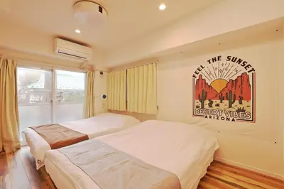 a bedroom with two beds and a poster on the wall at V.Close to Shinjuku Kabukicho/Korean Town/FrWIFI D in Tokyo