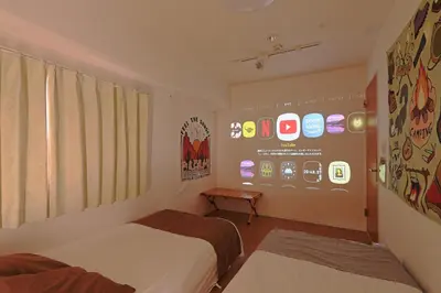 a room with two beds and a display of iphones at V.Close to Shinjuku Kabukicho/Korean Town/FrWIFI D in Tokyo