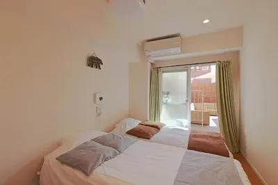 a bedroom with a large white bed with a window at V.Close to Shinjuku Kabukicho/Korean Town/FrWIFI D in Tokyo