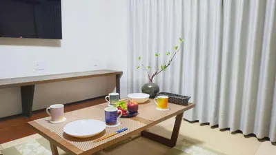 a table with plates and fruit on it in a room at HIRAI UTOPIA HOTEL in Tokyo