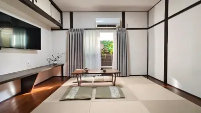 a living room with a table and a window at HIRAI UTOPIA HOTEL in Tokyo
