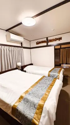 a hotel room with two beds in a room at HIRAI UTOPIA HOTEL in Tokyo
