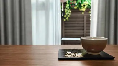 a bowl sitting on a black plate on a table at HIRAI UTOPIA HOTEL in Tokyo