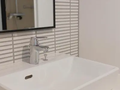 a bathroom sink with a faucet and a mirror at THE TOURIST HOTEL & Cafe AKIHABARA in Tokyo