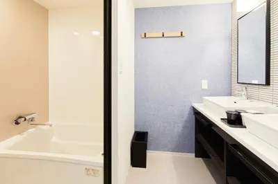 a bathroom with a white tub and a sink at THE TOURIST HOTEL & Cafe AKIHABARA in Tokyo