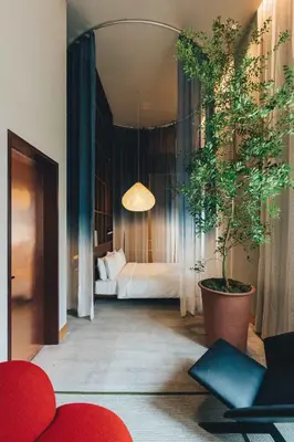 a hotel room with a bed and a potted plant at Hotel K5 in Tokyo