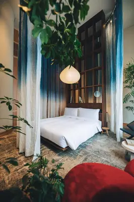 a bedroom with a white bed and a tree at Hotel K5 in Tokyo