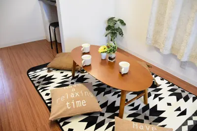a dining room table and a rug with a table and chairs at Gracias Shibuya - Great Access to Shinjuku & Shibuya in Tokyo