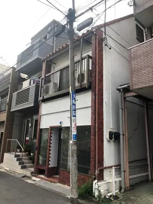 a street sign on a pole in front of a building at Gracias Shibuya - Great Access to Shinjuku & Shibuya in Tokyo