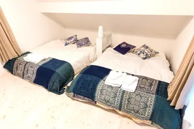 two beds sitting next to each other in a room at Gracias Shibuya - Great Access to Shinjuku & Shibuya in Tokyo