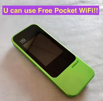 a green cell phone sitting on a table at Gracias Shibuya - Great Access to Shinjuku & Shibuya in Tokyo