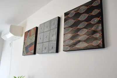three pieces of art hanging on a wall at Gracias Shibuya - Great Access to Shinjuku & Shibuya in Tokyo