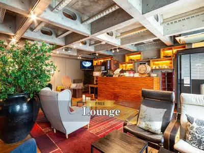 a lobby with a fire lounge with chairs and a table at Hotel Balian Resort Shinjuku Honten in Tokyo